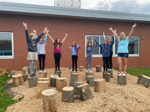 students standing on stumps